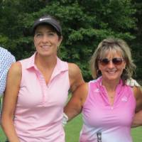 Four people on course smiling